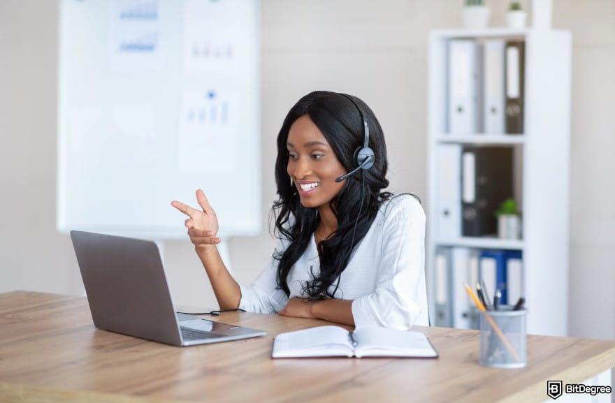 How to make a money online in Nigeria: a woman smiling while communicating with client online.