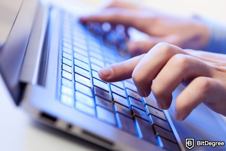 How to make money with AI: A man typing on a laptop keyboard.