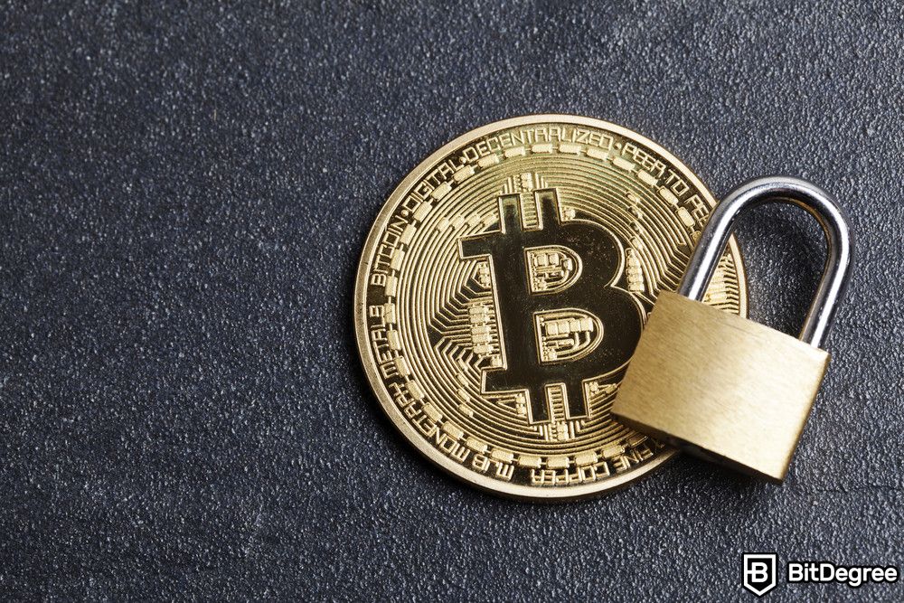 How to pay with Bitcoin: Bitcoin and a padlock on a dark surface.