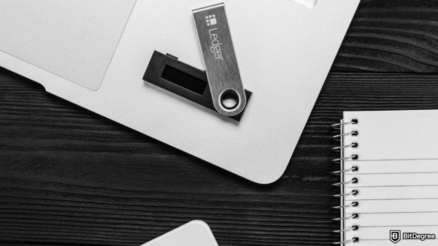 How to recover Ledger: a Ledger wallet device on a laptop beside a note.