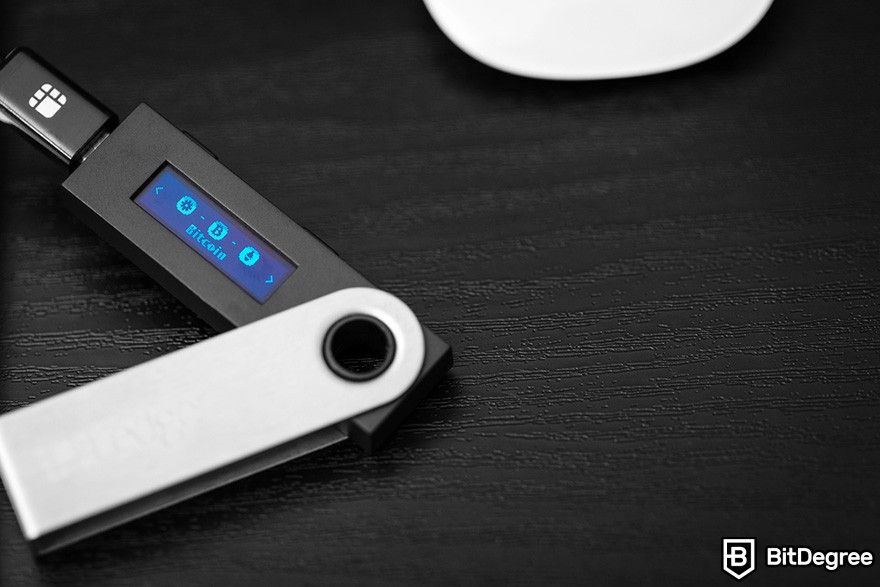 How to sell crypto from cold wallet: a Ledger wallet device connected via a USB cable.