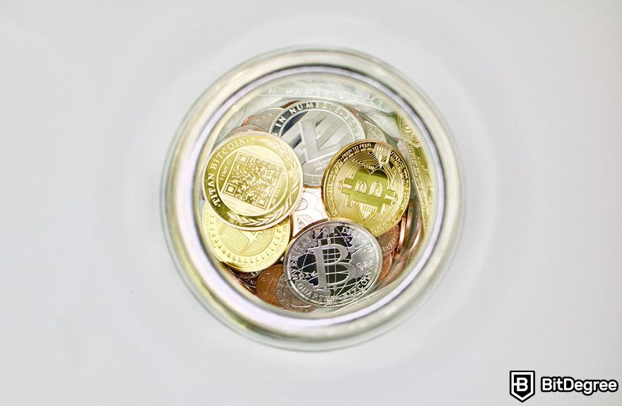 How to send Bitcoin to another wallet: various cryptocurrency coins in a glass jar.