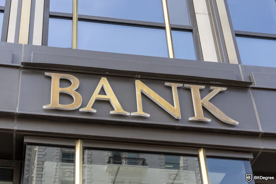 How to send money online: a building with the word BANK on the front.