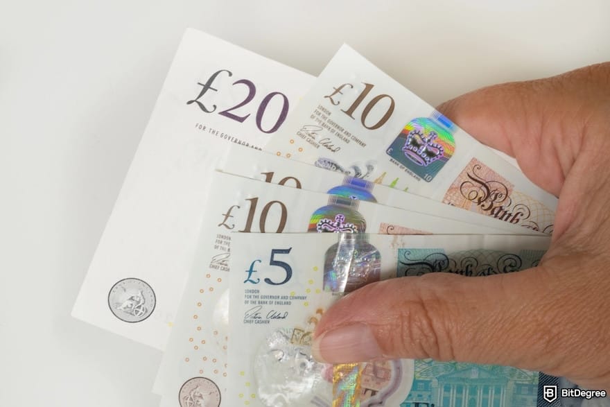 How to send money to Nigeria from the UK: a person holding the banknotes of the pound sterling.