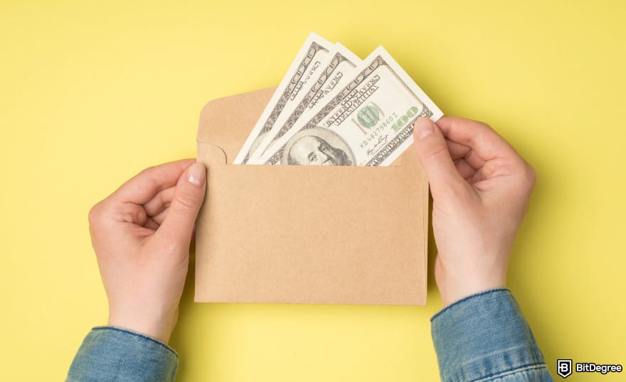 How to send money to someone without a bank account: person holding envelope with money to illustrate sending money.