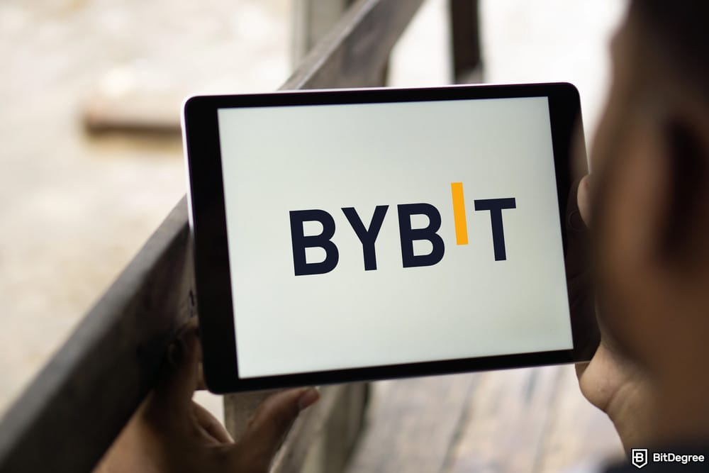 How to short crypto on Coinbase: Bybit's logo shown on a tablet.
