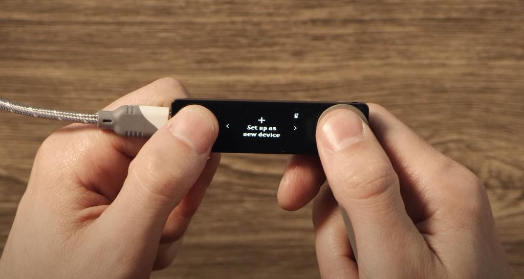 How to stake Solana: a person holding the Ledger Nano X wallet.