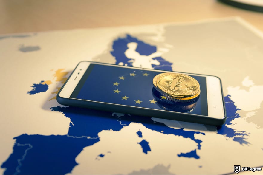How to transfer crypto from Kraken: a smartphone with the EU logo and a few Bitcoins on top of it.
