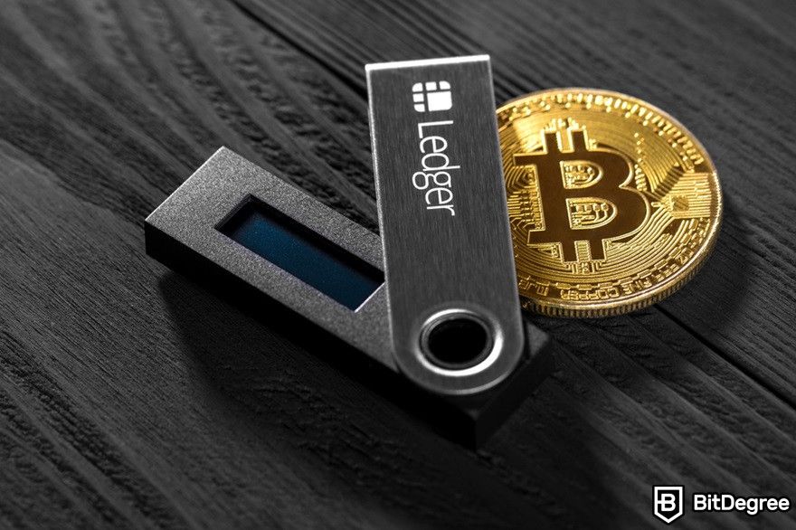 How to transfer crypto to bank account: Ledger Nano X on a wooden background.