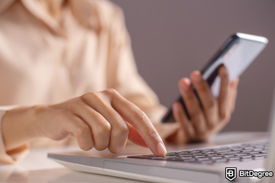 How to transfer crypto to bank account: woman hand enter a one time password for the two-authentication process.