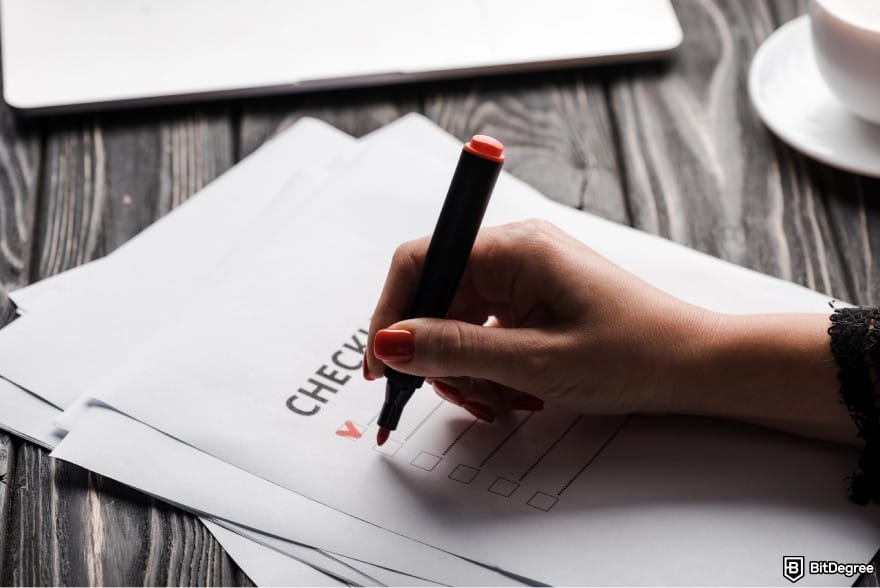 How to transfer money from bank account: a person writing a checklist.