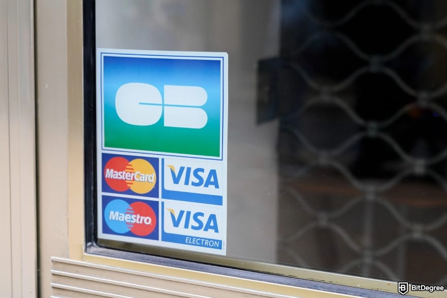 How to transfer money from Chime to bank account: VISA signs on a window.