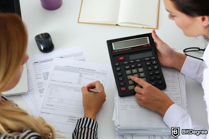 How to transfer USDC to bank account: two female accountants using a calculator.