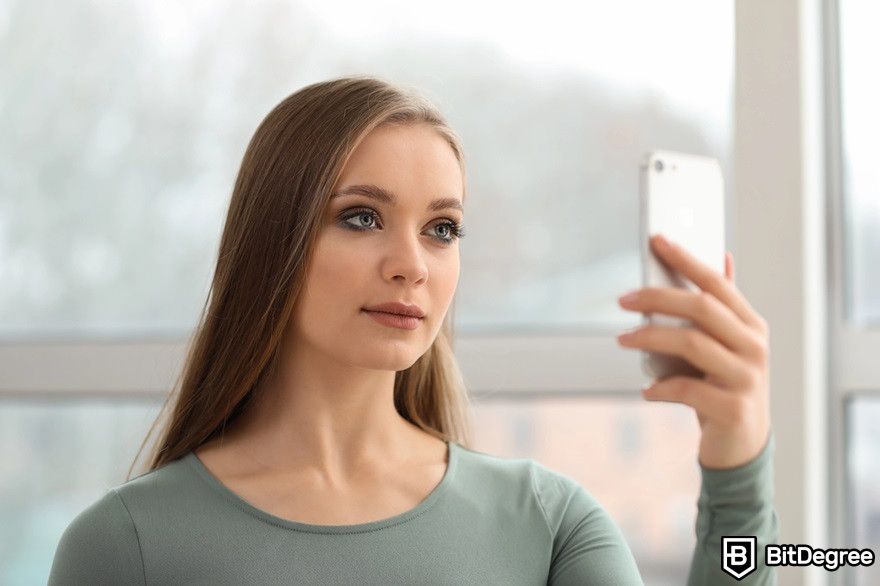 How to transfer USDC to bank account: a woman taking selfie for identity verification.