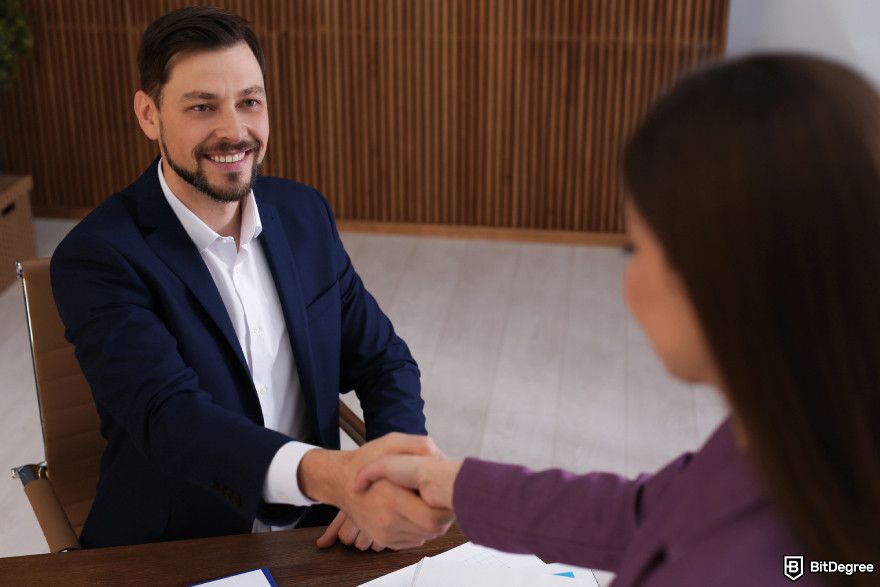 How to turn crypto into cash: a broker shaking hands with a customer.