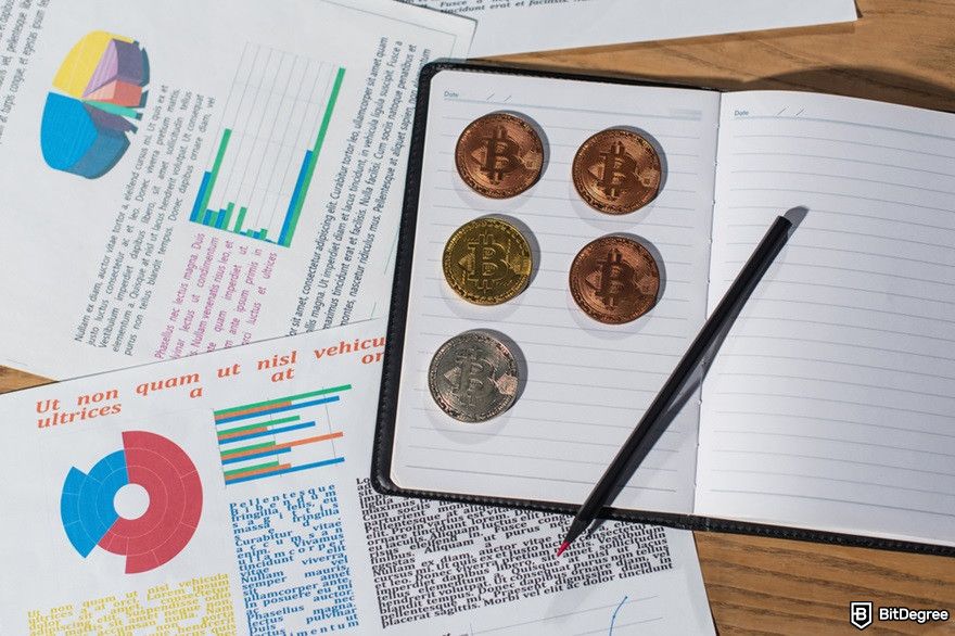 How to use AI for crypto trading: a top view of coins on a notebook.