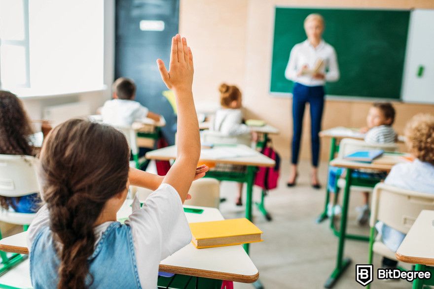 How to use ChatGPT: Girl raising hand in class.