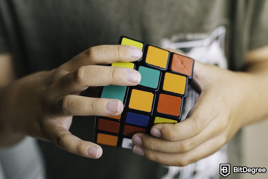 How to use ChatGPT: Man solving Rubik's cube.