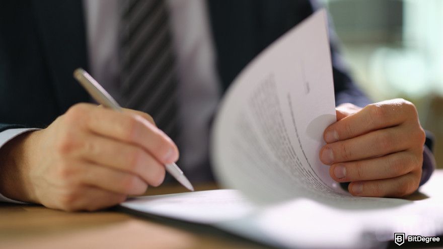 How to use MEXC: a person in suit signing document at work in office closeup.