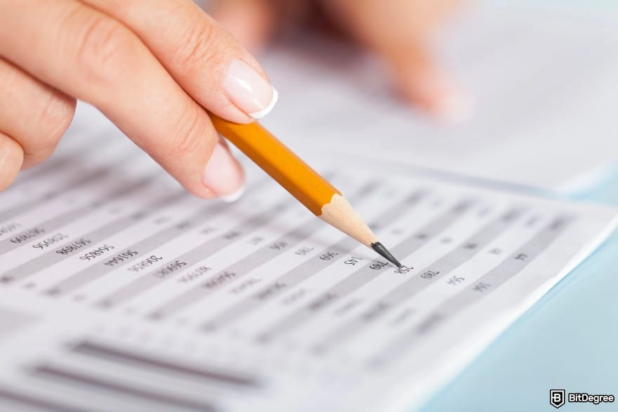 How to wire money: a hand holding a pencil while reviewing the balance sheet from the bank.