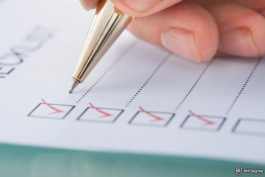 How to wire money: a hand ticking the box on a checklist.