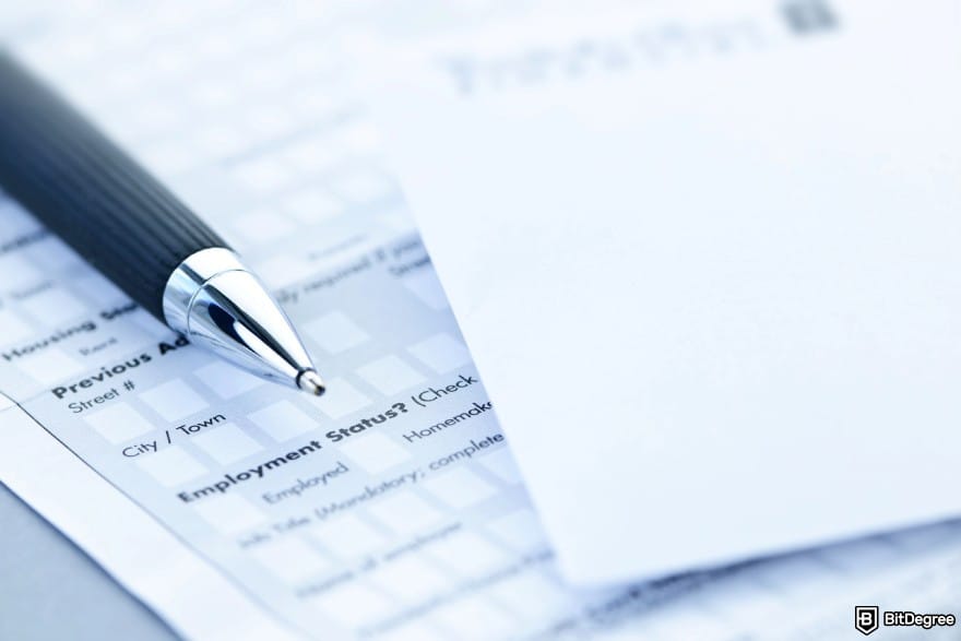 How to wire money: a bank form and a metal pen.
