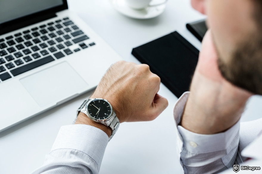 How to withdraw crypto from Uphold: closeup of a person checking time on hand watch.