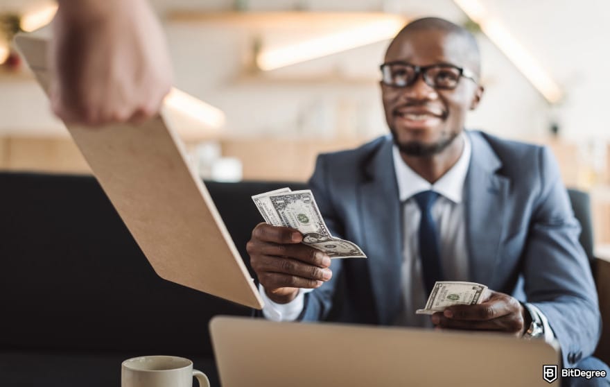 How to Withdraw From Binance in Nigeria: man paying to illustrate paying for crypto network fees.