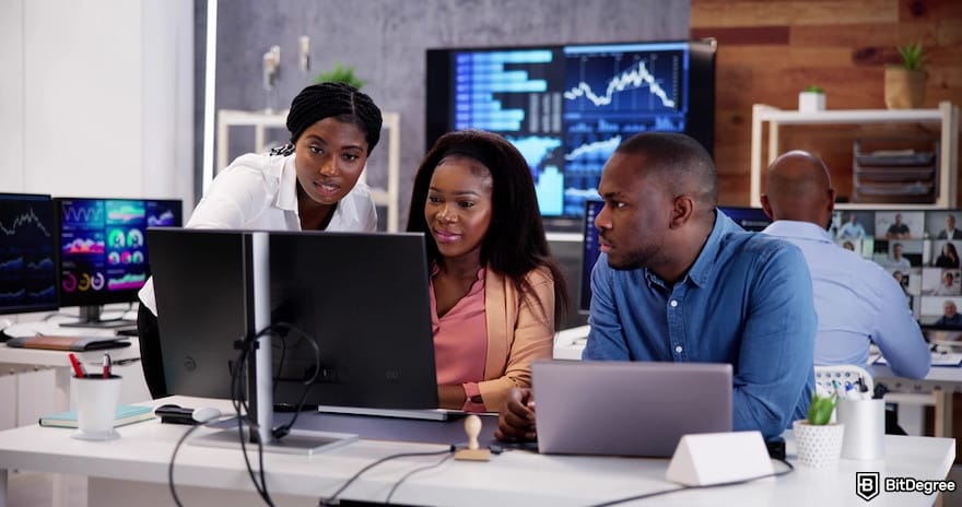 How to withdraw from KuCoin to Nigeria bank: African financial data analyst looking at a computer.