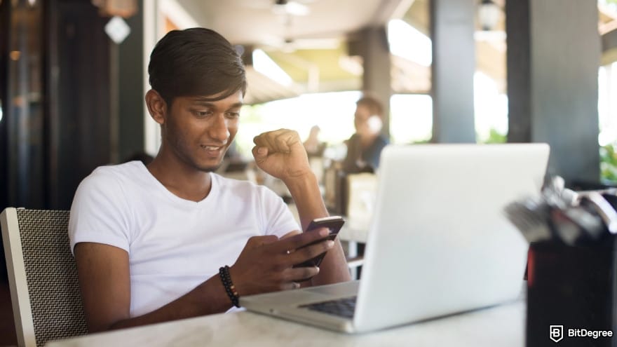 How to withdraw money from Binance in India: a person using smartphone and laptop.