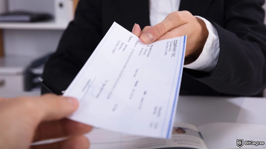 How to withdraw money from Binance Wallet: a person handing over check.