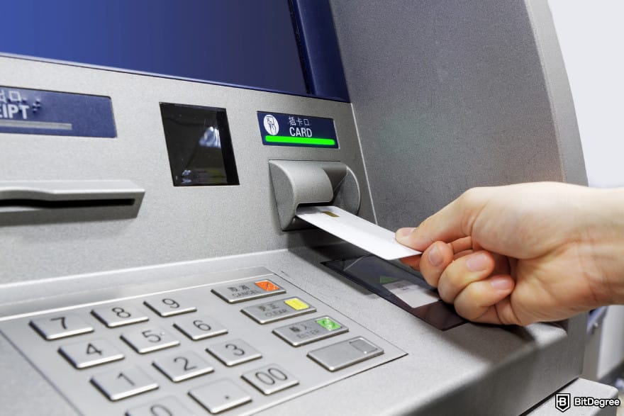 How to withdraw money from Cash App: a person inserting a card into an ATM. How to withdraw money from Cash App: a person inserting a card into an ATM.