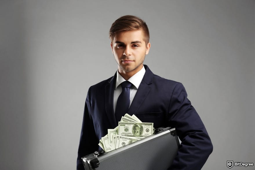 How to withdraw money from OKX in India: business person holding case with money. How to withdraw money from OKX in India: business person holding case with money.