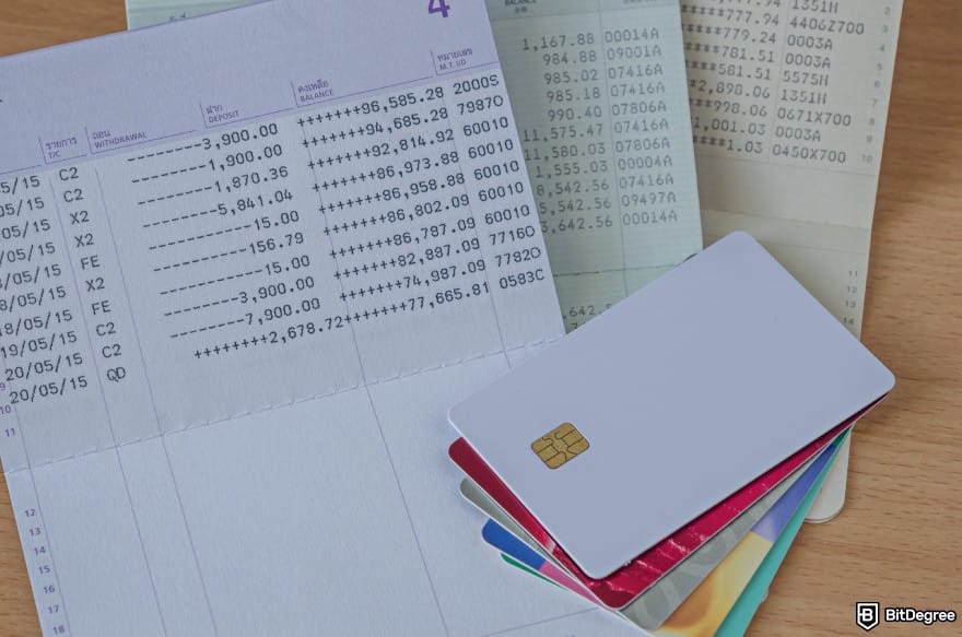 How to withdraw money from PayPal: a bank book and stacked cards.