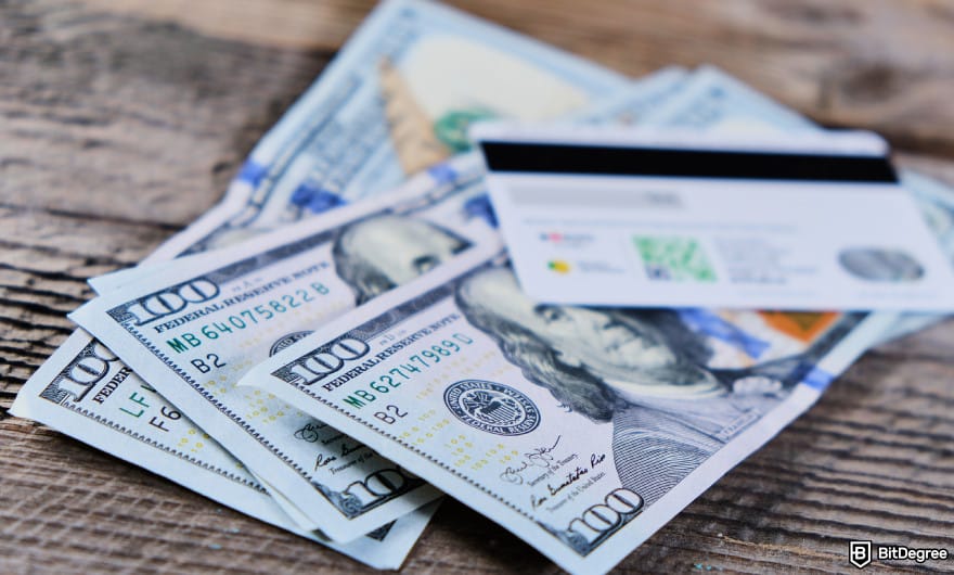 How to withdraw money from prepaid card online: USD bills and card to illustrate prepaid card bank transfer. How to withdraw money from prepaid card online: USD bills and card to illustrate prepaid card bank transfer.