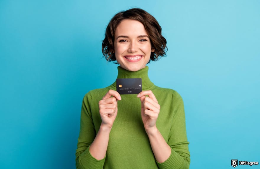 How to withdraw money from prepaid card online: woman holding card. How to withdraw money from prepaid card online: woman holding card.