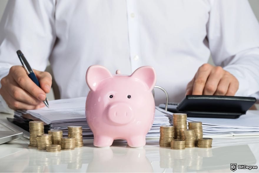 How to withdraw money from savings account: a piggy bank next to piles of coins.