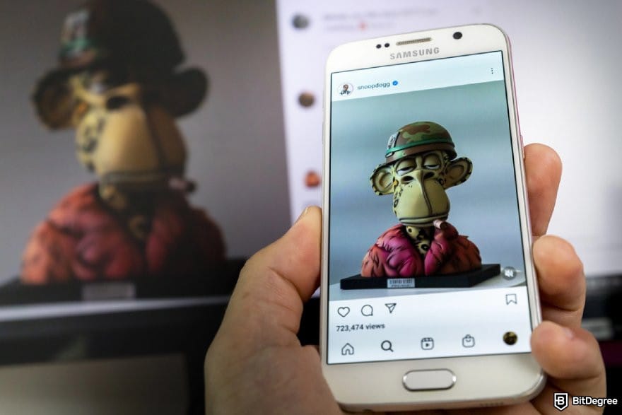 How to withdraw money from Webull: a hand holding a phone displaying SnoopDogg's Instagram post about NFT.