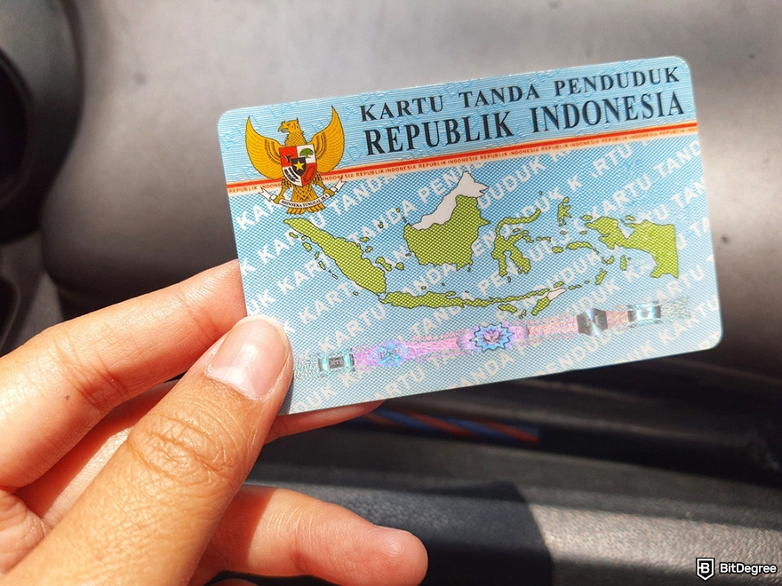 Indodax review: a hand holding an Indonesian ID card.