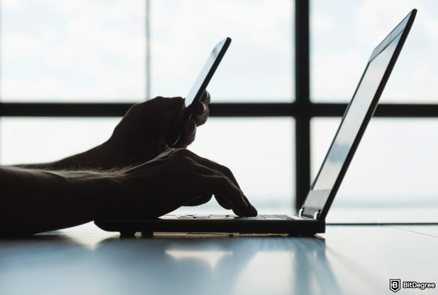 Is BitMart safe: a person using a phone and a laptop.