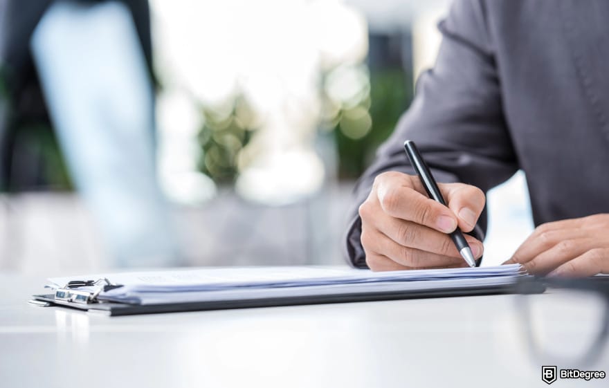 Is BitMart safe: a man signing a document.