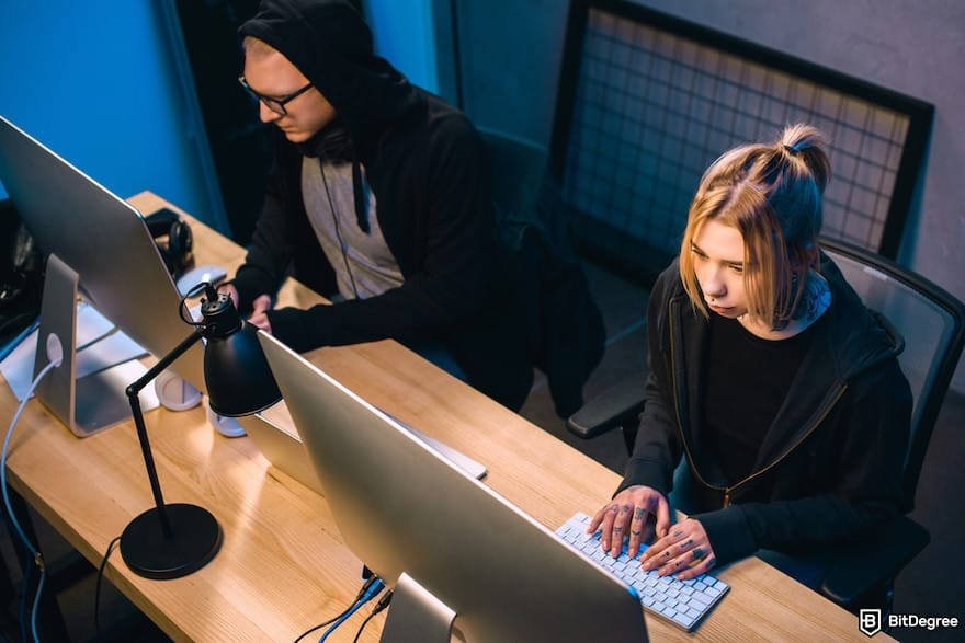 Is Bybit safe: a high angle view of couple of hackers working on malware Is Bybit safe: a high angle view of couple of hackers working on malware