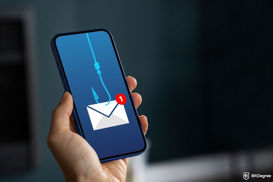 Is Bybit safe: a hand holding a mobile phone displaying an image of an envelop attached to a fishing hook.