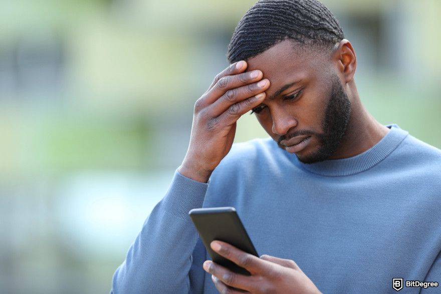 Is Coinbase safe: a man facepalming seeing his phone.