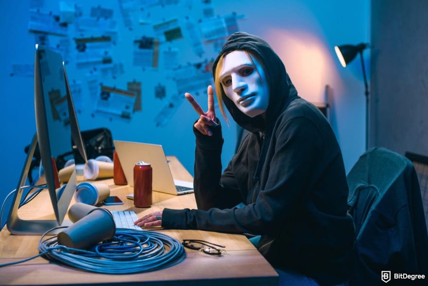 Is Kraken safe: a hacker in mask showing v sign.