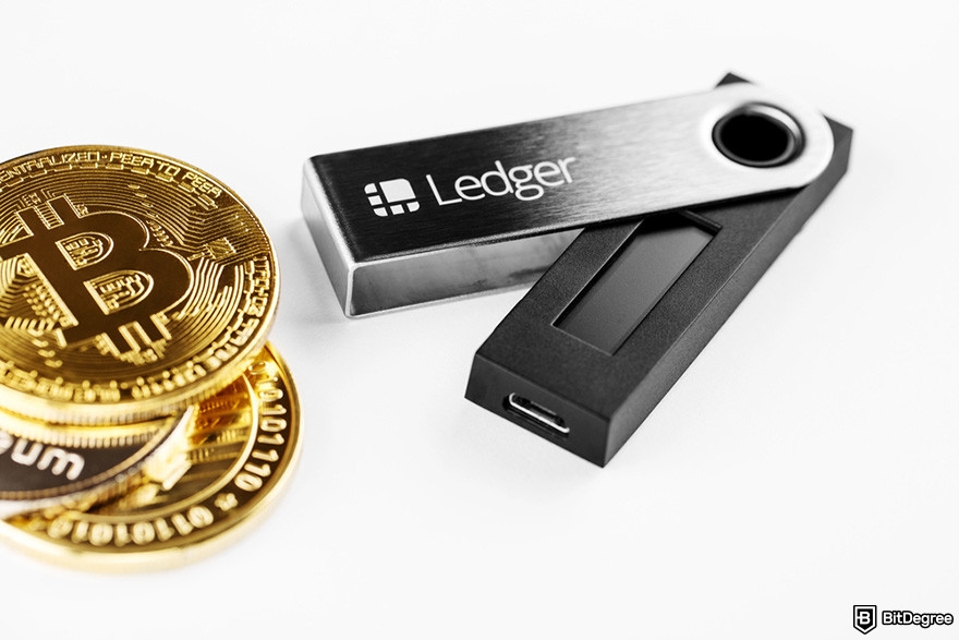 is MetaMask safe: a stack of BTC coins and a Ledger wallet device.