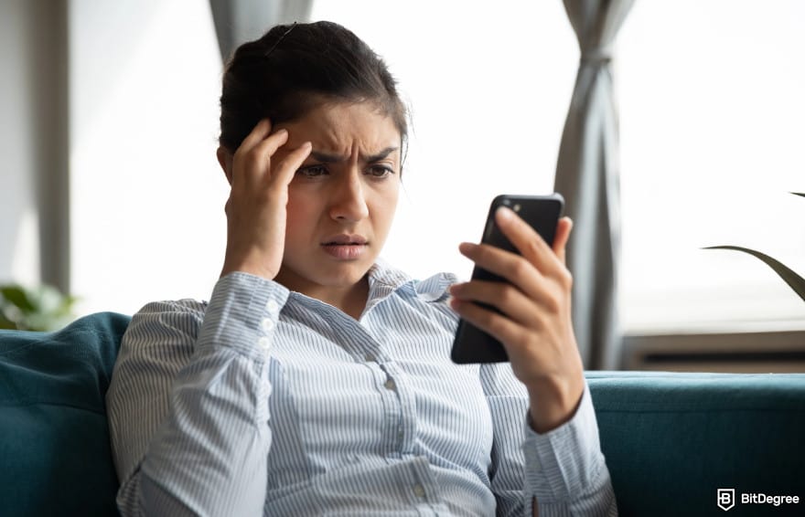 Is PayPal available in India: woman holding phone to illustrate frustrations for PayPal limitations in India.