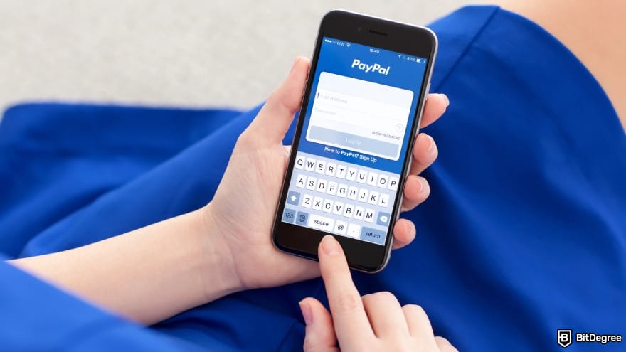 Is PayPal available in Philippines: a person holding a phone PayPal on the screen.