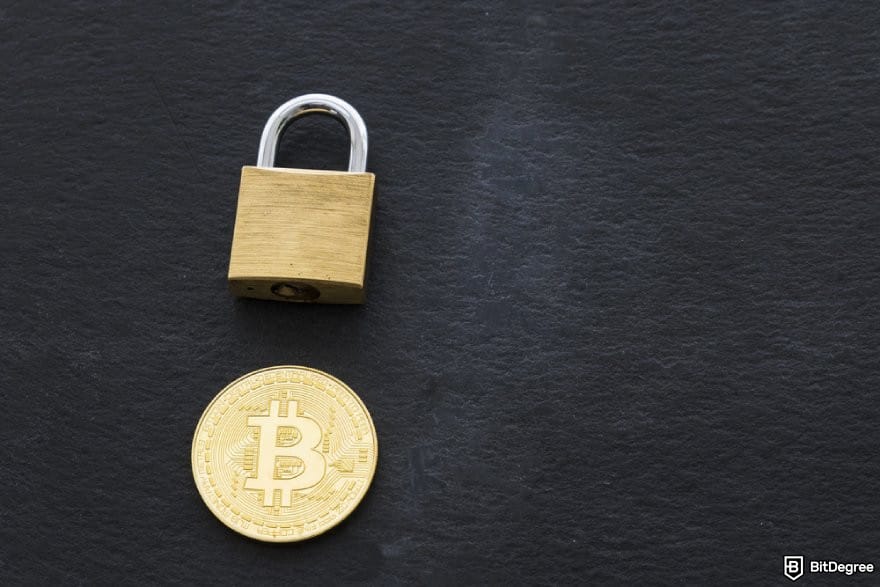 Is Robinhood safe: a golden BTC coin and a padlock on a dark surface.