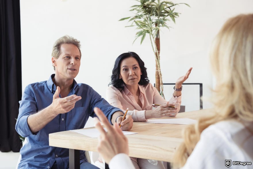 Is Robinhood safe: a group of people debating with a blonde woman.